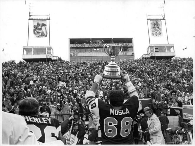 Hamilton Spectator file photo of Angelo Mosca presenting the Grey Cup to spectators at Ivor Wynne stadium after the Hamilton Tiger-Cats defeated the Saskatchewan Roughriders 13-10 on an Ian Sunter 34 yard field goal on the last play of the game. ivor wynne stadium hamilton historical collection