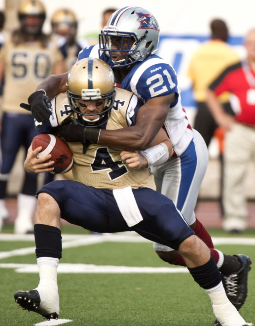 Winnipeg Blue Bombers quarterback Buck Pierce is sacked by Montreal Alouettes linebacker Mike Edem during first quarter CFL football action Thursday, July 4, 2013 in Montreal. THE CANADIAN PRESS/Paul Chiasson