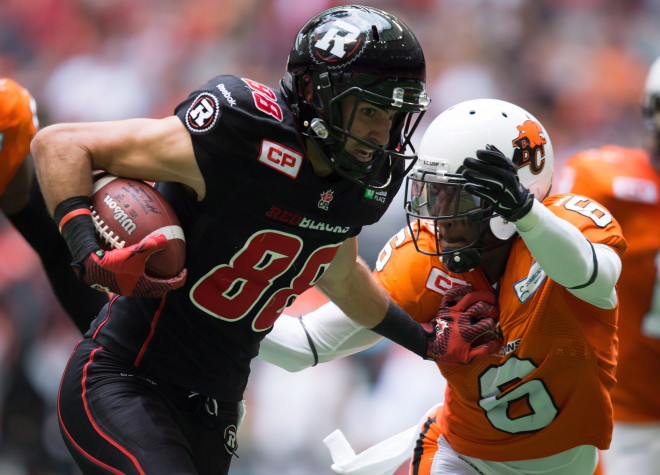 Ottawa Redblacks' Brad Sinopoli, left, fights off B.C. Lions' T.J. Lee (6) as he carries the ball after making a reception during the first half of a CFL football game in Vancouver, B.C., on Sunday, September 13, 2015. THE CANADIAN PRESS/Darryl Dyck