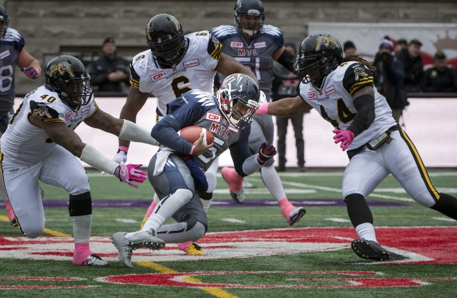 Montreal Alouettes Kevin Glenn runs into Hamilton Tiger-Cats defence during 1half CFL action in Montreal on Sunday October 18, 2015 (CFL PHOTO - Peter McCabe)