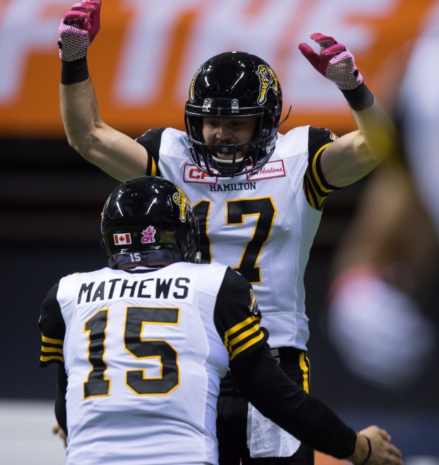 Hamilton Tiger-Cats' Luke Tasker (17) and quarterback Jeff Mathews celebrate Tasker's touchdown against the B.C. Lions during the first half of a CFL football game in Vancouver, B.C., on Friday October 23, 2015. THE CANADIAN PRESS/Darryl Dyck