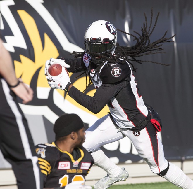 Ottawa Redblacks' defensive back Abdul Kanneh (14) celebrates his end-zone reception while Hamilton Tiger-Cats' Brandon Banks (16), lower left, sits on the turf during second-half CFL football action in Hamilton, Ont., on Sunday, Nov. 1, 2015. THE CANADIAN PRESS/Peter Power