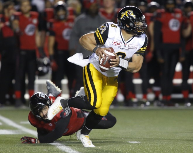 The Hamilton Tiger-Cats quarterback Jeremiah Masoli avoids a tackle from Ottawa Redblacks Justin Capicciotti during third quarter CFL action in Ottawa on Saturday, November 7, 2015. (CFL PHOTO - Patrick Doyle)