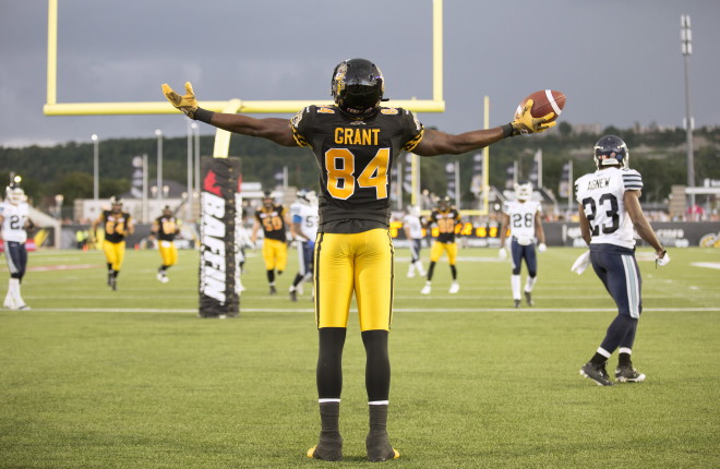 Hamilton Tiger-Cats' wide receiver Bakari Grant (84) celebrates his touch-down during first-half CFL football action in Hamilton on Monday, August 3, 2015. THE CANADIAN PRESS/Peter Power