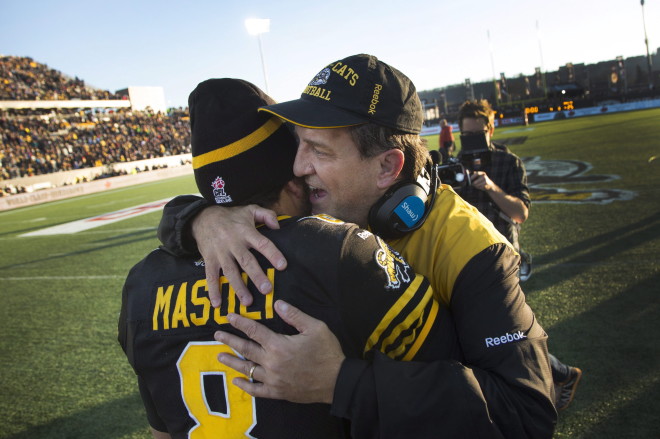 Hamilton Tiger-Cats' head coach Kent Austin whispers in the ear of Hamilton Tiger-Cats' quarterback Jeremiah Masoli (8)second half CFL Eastern Division Semifinal football action, in Hamilton, Ont., on Sunday, Nov. 15, 2015. The Hamilton Tiger-Cats defeated the Toronto Argonauts 25-22 with a last play field goal by Hamilton Tiger-Cats p/k Justin Medlock (7). THE CANADIAN PRESS/Peter Power