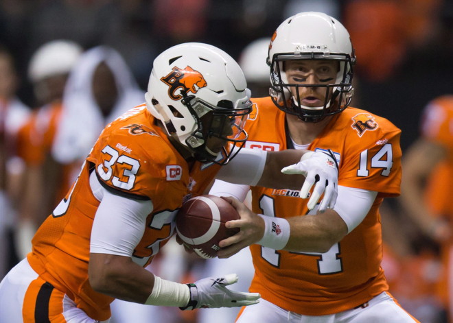 B.C. Lions' quarterback Travis Lulay, right, hands off to Andrew Harris during the first half of a CFL football game against the Toronto Argonauts in Vancouver, B.C., on Friday July 24, 2015. A roller-coaster start to the CFL season has the Lions searching for consistency. THE CANADIAN PRESS/Darryl Dyck