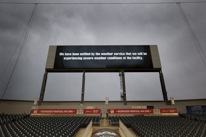 CFL fans clear the stands due to a threat of severe weather prior to CFL action between the Winnipeg Blue Bombers and the Hamilton Tiger-Cats in Winnipeg Wednesday, August 3, 2016. THE CANADIAN PRESS/John Woods