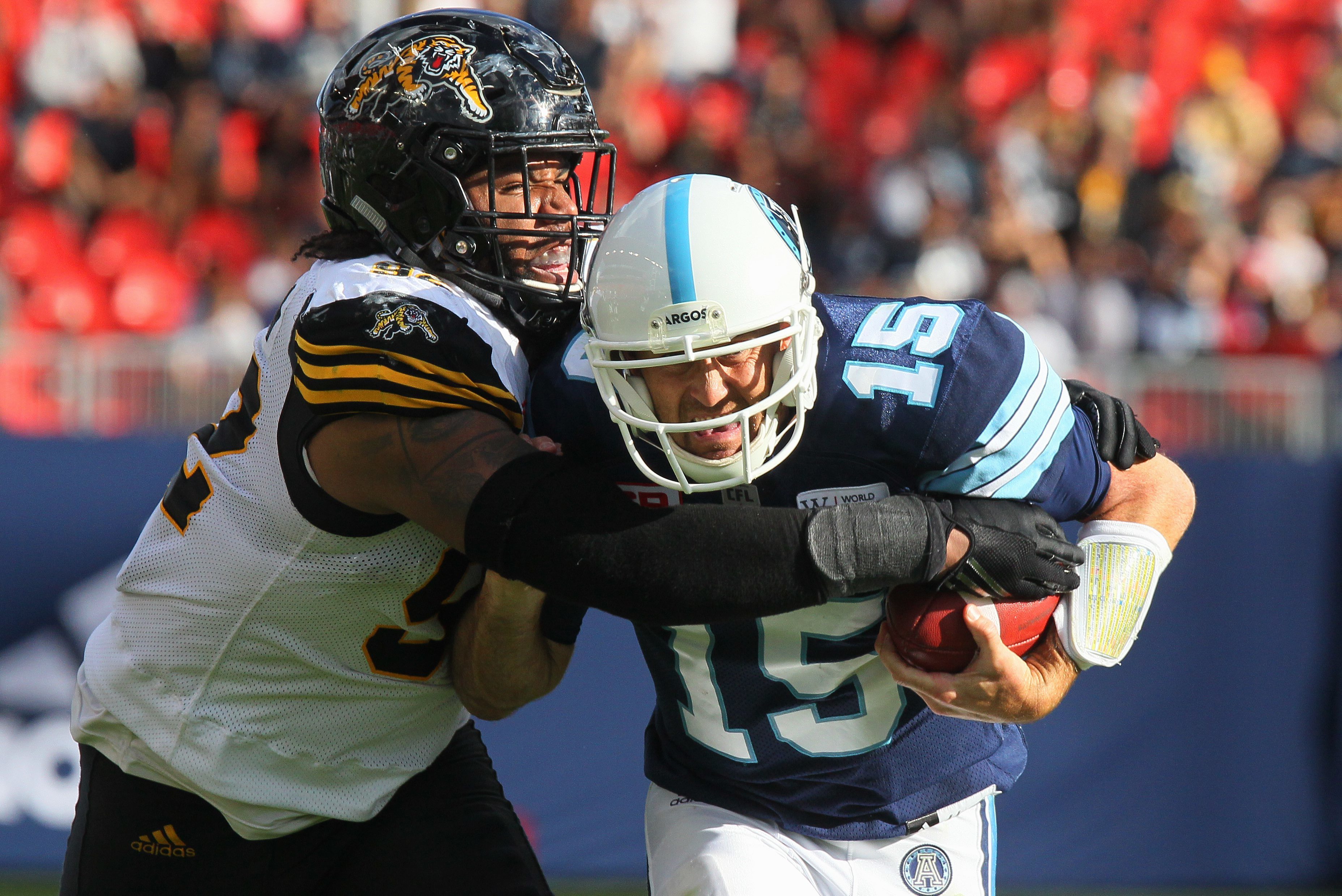 Argos' quarterback Ricky Ray tries to elude Ticats' Justin Vaughn during forth quarter CFL action in Toronto on Sunday, June 25, 2017. (CFL PHOTO - Dave Chidley)